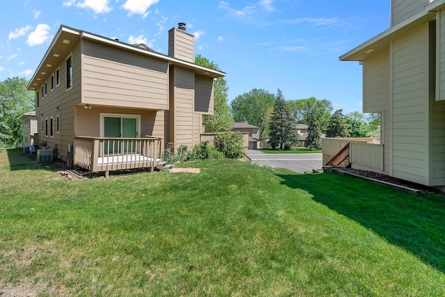 2111 Tamarin Trl, Golden Valley, MN 55427 - view of grassy yard featuring a deck and central AC