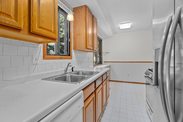 2111 Tamarin Trl, Golden Valley, MN 55427 - kitchen featuring freestanding refrigerator, a sink, backsplash, and light countertops