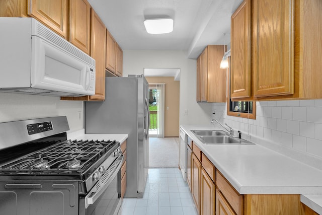 2111 Tamarin Trl, Golden Valley, MN 55427 - kitchen featuring stainless steel gas range oven, white microwave, a sink, and light countertops
