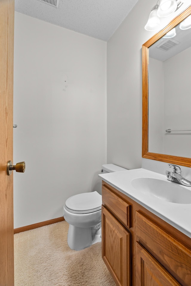 2111 Tamarin Trl, Golden Valley, MN 55427 - half bathroom featuring vanity, toilet, and a textured ceiling