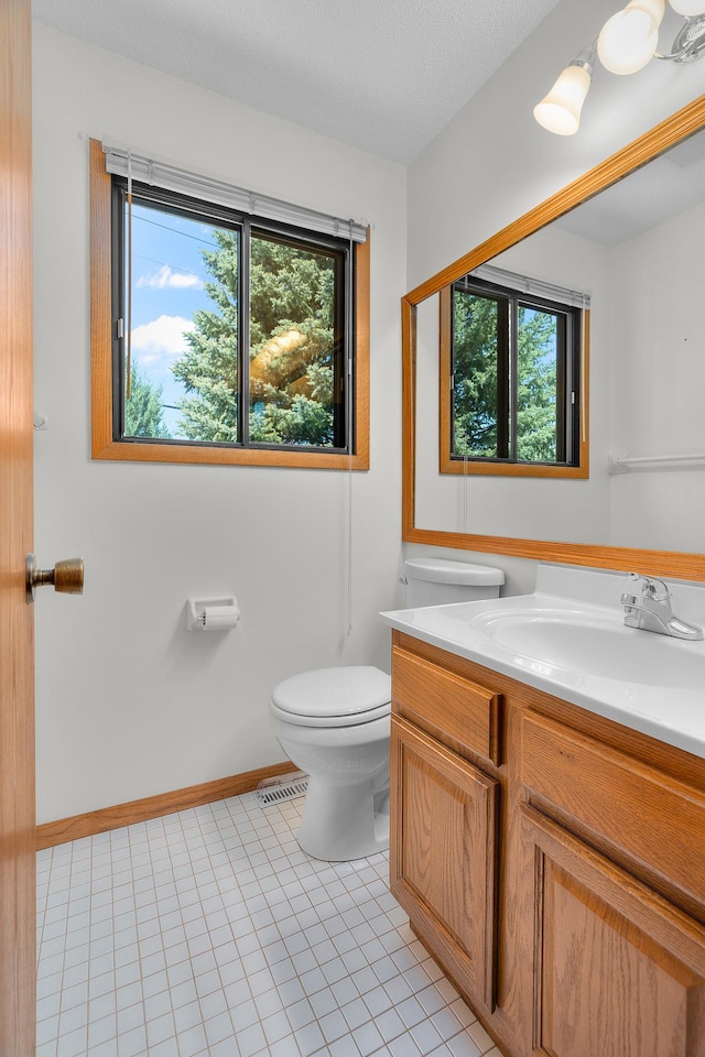 2111 Tamarin Trl, Golden Valley, MN 55427 - bathroom with toilet, vanity, and tile patterned flooring