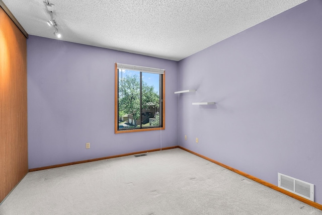 2111 Tamarin Trl, Golden Valley, MN 55427 - unfurnished room with carpet, a textured ceiling, and baseboards