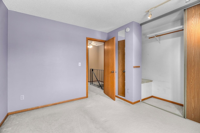 2111 Tamarin Trl, Golden Valley, MN 55427 - unfurnished bedroom with carpet floors, a closet, baseboards, and a textured ceiling