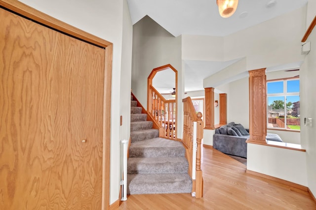 13883 Holly St NW, Andover, MN 55304 - foyer entrance featuring wood finished floors, stairs, ornate columns, and baseboards