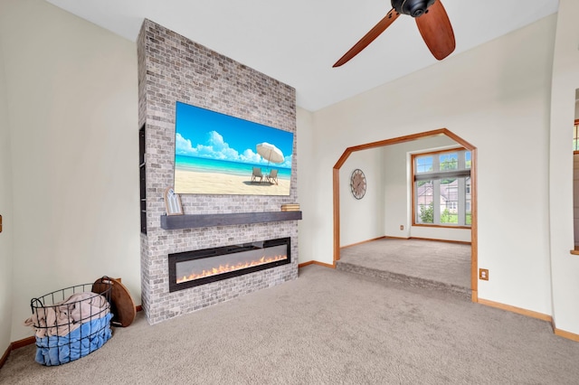 13883 Holly St NW, Andover, MN 55304 - unfurnished living room featuring carpet flooring, ceiling fan, a fireplace, and baseboards