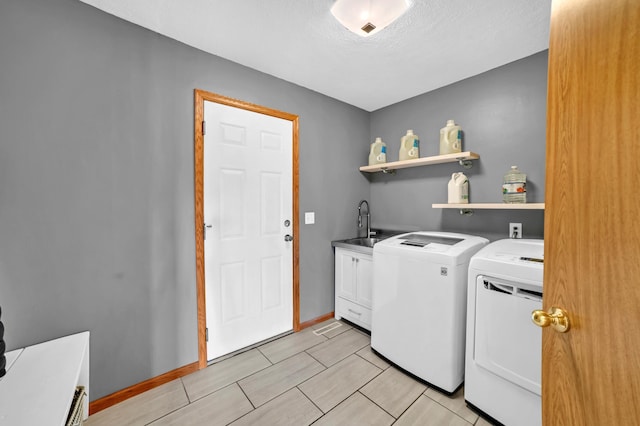 13883 Holly St NW, Andover, MN 55304 - washroom featuring cabinet space, independent washer and dryer, and baseboards