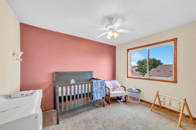 13883 Holly St NW, Andover, MN 55304 - carpeted bedroom with baseboards, a crib, and ceiling fan