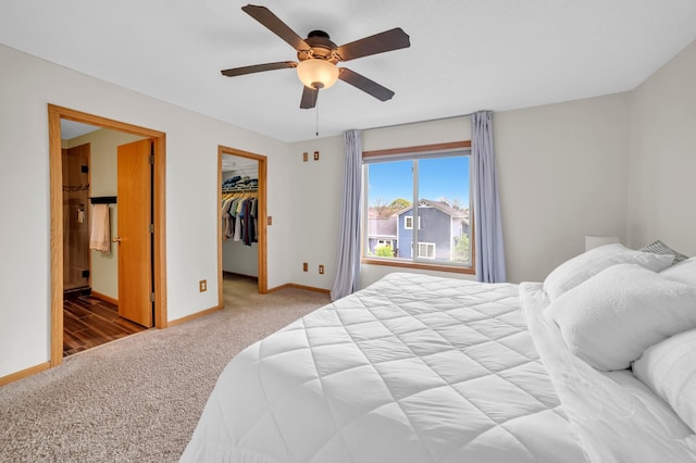 13883 Holly St NW, Andover, MN 55304 - carpeted bedroom with baseboards, a walk in closet, ceiling fan, and a closet