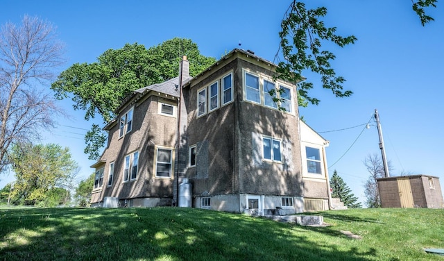 23142 Denmark Ave, Castle Rock Twp, MN 55024 - view of side of property with a chimney, a lawn, a storage unit, and an outdoor structure