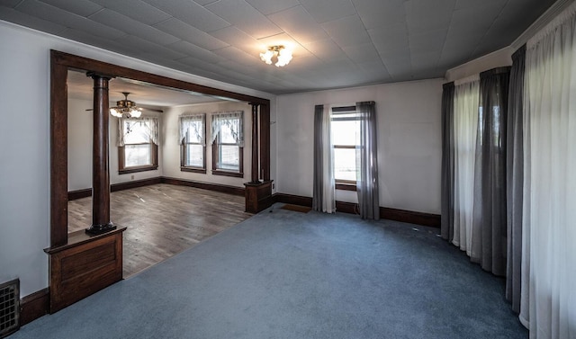 23142 Denmark Ave, Castle Rock Twp, MN 55024 - unfurnished room with ornate columns, baseboards, carpet, and crown molding