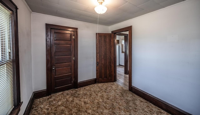 23142 Denmark Ave, Castle Rock Twp, MN 55024 - unfurnished bedroom with ornamental molding, baseboards, and carpet flooring