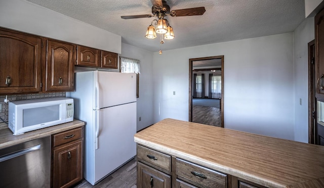 23142 Denmark Ave, Castle Rock Twp, MN 55024 - kitchen with white appliances, dark wood-style flooring, a textured ceiling, a ceiling fan, and dark brown cabinets
