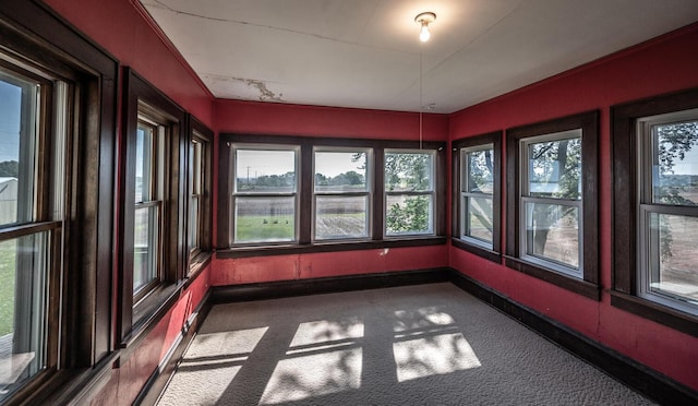 23142 Denmark Ave, Castle Rock Twp, MN 55024 - unfurnished sunroom featuring carpet flooring, a water view, and baseboards