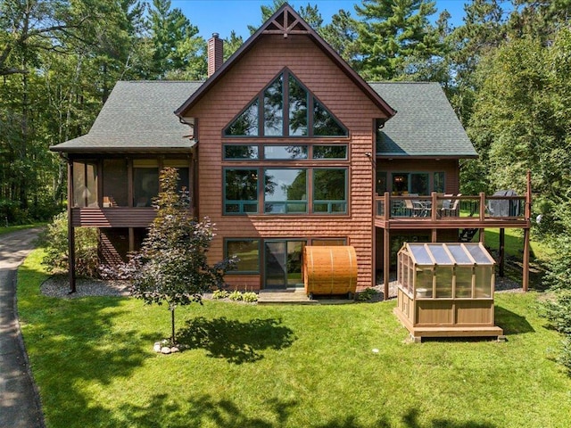 26746 County Road 4, Nisswa, MN 56468 - back of property with an exterior structure, a chimney, a yard, and a wooden deck