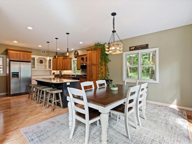 26746 County Road 4, Nisswa, MN 56468 - dining room with plenty of natural light, light wood-style flooring, baseboards, recessed lighting, and a chandelier