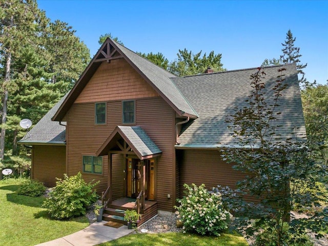 26746 County Road 4, Nisswa, MN 56468 - rustic home featuring a front lawn and a shingled roof