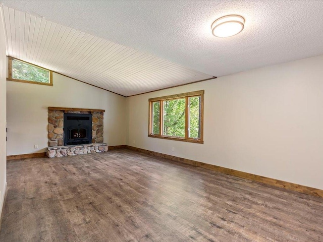 26746 County Road 4, Nisswa, MN 56468 - unfurnished living room with wood finished floors, a fireplace, baseboards, and lofted ceiling