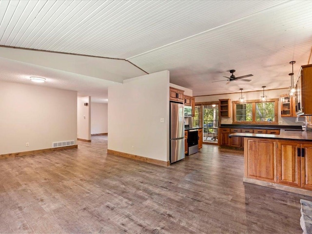 26746 County Road 4, Nisswa, MN 56468 - kitchen featuring appliances with stainless steel finishes, dark countertops, dark wood-style floors, and open floor plan