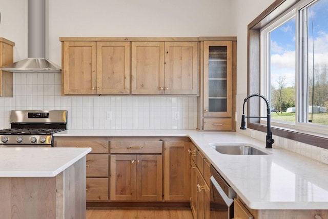 21346 Cottonwood St NW, Oak Grove, MN 55011 - kitchen featuring wall chimney range hood, stainless steel gas stove, a sink, dishwashing machine, and decorative backsplash
