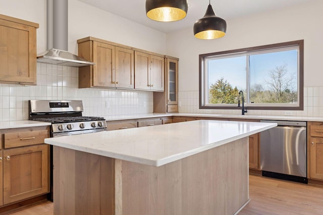 21346 Cottonwood St NW, Oak Grove, MN 55011 - kitchen with appliances with stainless steel finishes, wall chimney exhaust hood, a sink, a center island, and backsplash