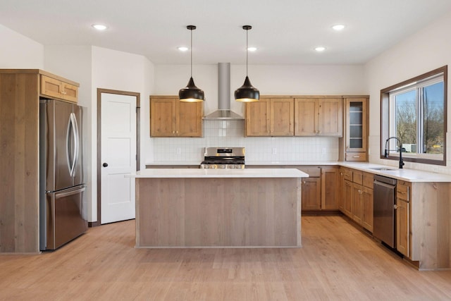 21346 Cottonwood St NW, Oak Grove, MN 55011 - kitchen featuring appliances with stainless steel finishes, wall chimney exhaust hood, a sink, light wood-type flooring, and light countertops