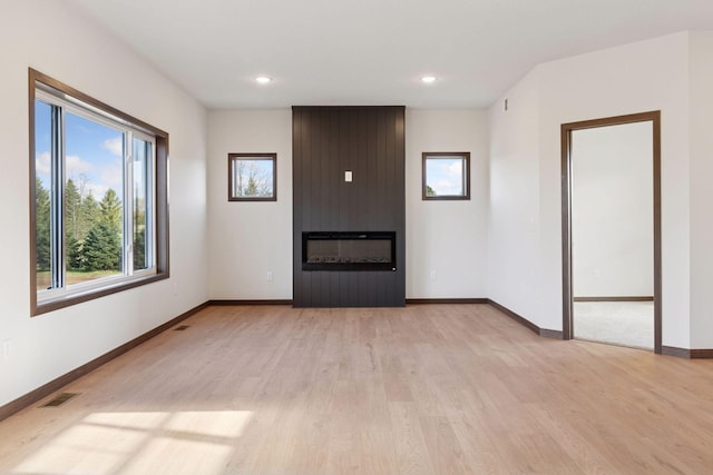 21346 Cottonwood St NW, Oak Grove, MN 55011 - unfurnished living room with a large fireplace, healthy amount of natural light, light wood finished floors, baseboards, and recessed lighting