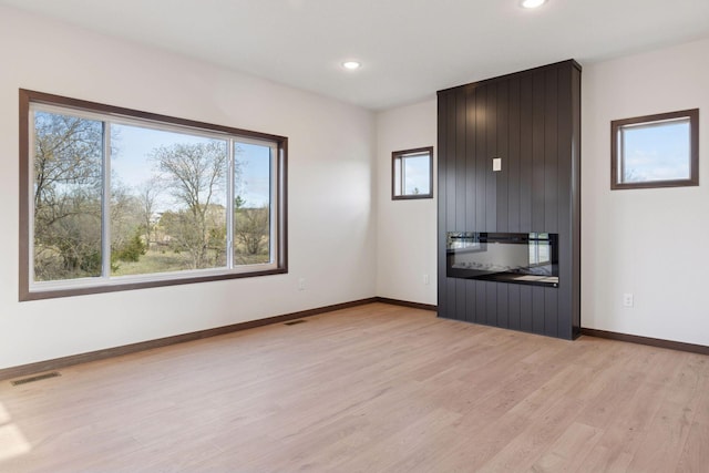 21346 Cottonwood St NW, Oak Grove, MN 55011 - empty room with light wood-style floors, recessed lighting, and baseboards