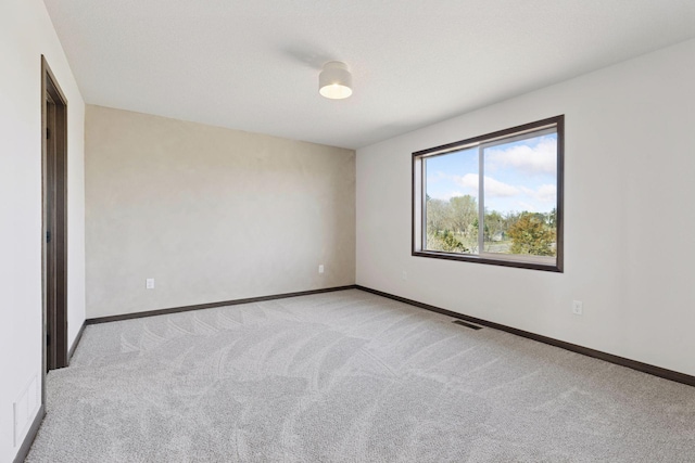 21346 Cottonwood St NW, Oak Grove, MN 55011 - spare room featuring carpet flooring and baseboards