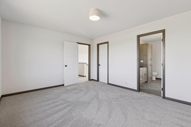 21346 Cottonwood St NW, Oak Grove, MN 55011 - unfurnished bedroom with carpet flooring, baseboards, and connected bathroom