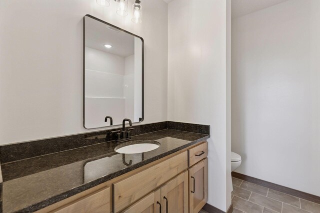 21346 Cottonwood St NW, Oak Grove, MN 55011 - bathroom with toilet, vanity, and baseboards