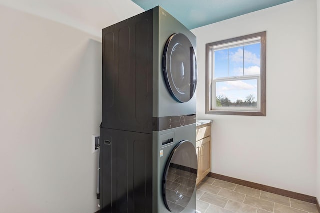 21346 Cottonwood St NW, Oak Grove, MN 55011 - laundry area with estacked washer and dryer, cabinet space, and baseboards