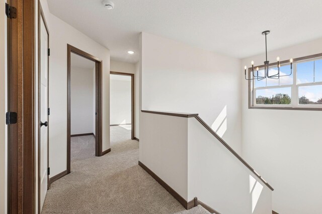 21346 Cottonwood St NW, Oak Grove, MN 55011 - hall featuring an upstairs landing, light carpet, baseboards, a chandelier, and recessed lighting
