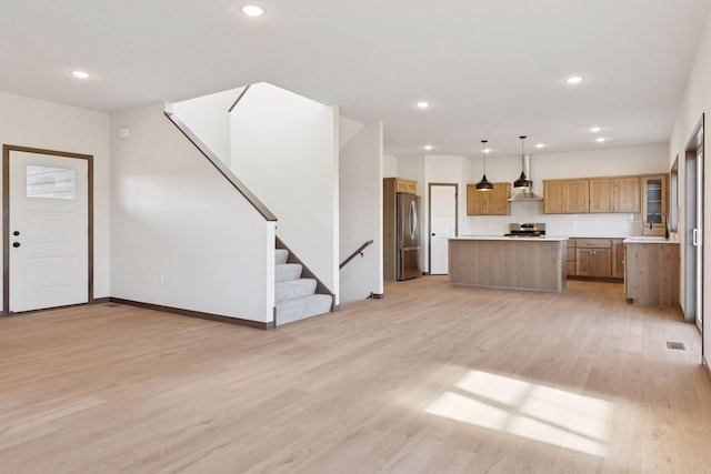 21346 Cottonwood St NW, Oak Grove, MN 55011 - unfurnished living room with light wood-style flooring, stairway, a sink, recessed lighting, and baseboards
