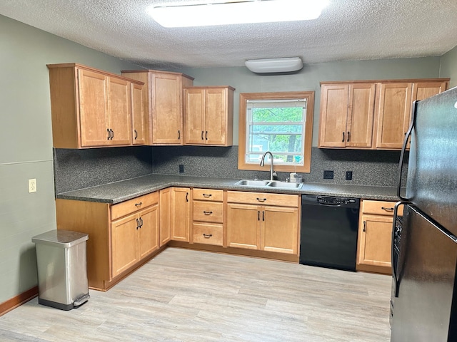 1429 Circle Dr, Albert Lea, MN 56007 - kitchen with black appliances, a sink, light wood-style flooring, a textured ceiling, and backsplash