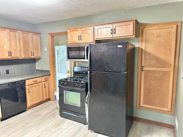 1429 Circle Dr, Albert Lea, MN 56007 - kitchen featuring black appliances, light wood-style floors, light brown cabinetry, and a textured ceiling