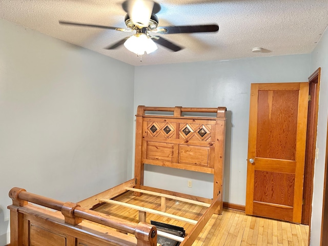 1429 Circle Dr, Albert Lea, MN 56007 - bedroom with light wood-style flooring, a textured ceiling, and ceiling fan