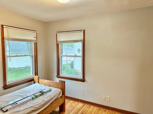 1429 Circle Dr, Albert Lea, MN 56007 - bedroom with light wood finished floors, baseboards, and a textured ceiling