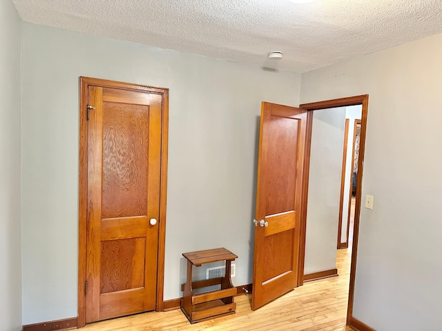 1429 Circle Dr, Albert Lea, MN 56007 - bedroom with light wood finished floors, a textured ceiling, and baseboards