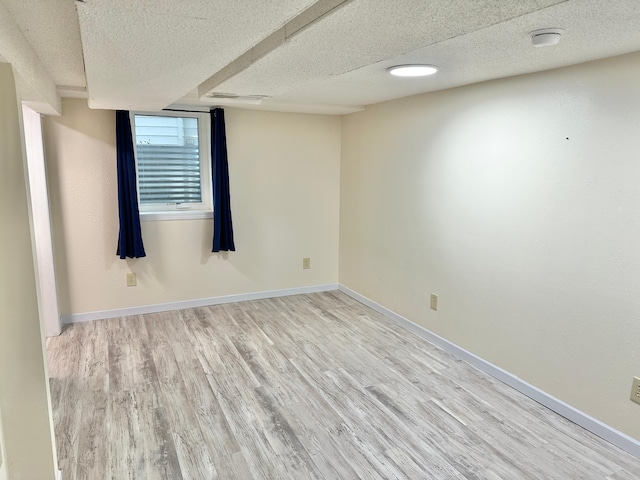 1429 Circle Dr, Albert Lea, MN 56007 - empty room featuring wood finished floors, a textured ceiling, and baseboards