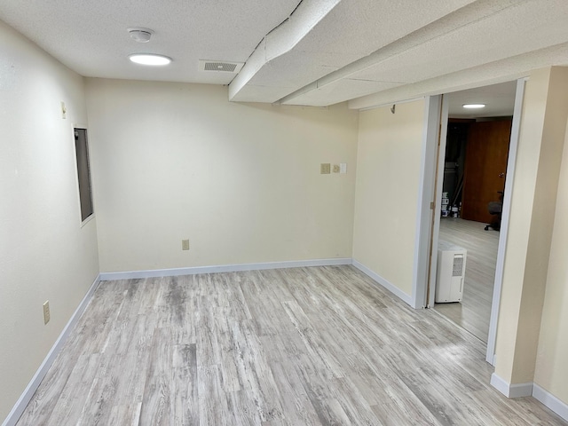 1429 Circle Dr, Albert Lea, MN 56007 - finished below grade area with light wood-style flooring, baseboards, and a textured ceiling