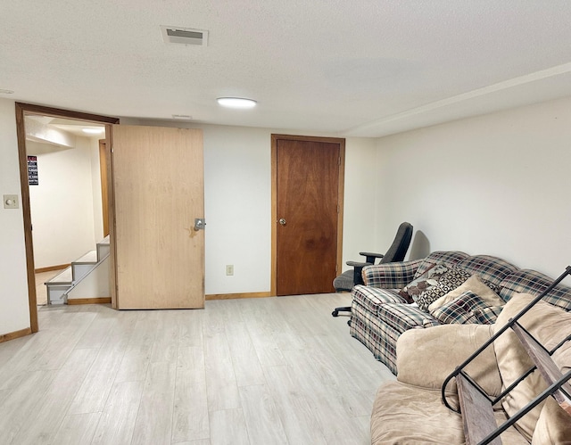1429 Circle Dr, Albert Lea, MN 56007 - living area with light wood finished floors, baseboards, and a textured ceiling
