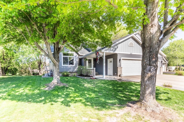 ranch-style home with an attached garage, concrete driveway, a front yard, and brick siding