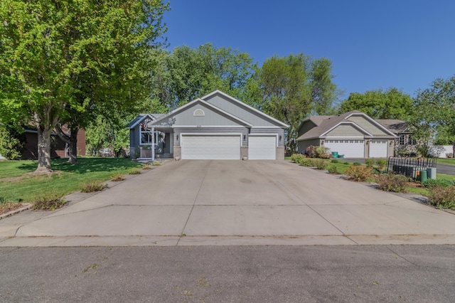 view of front of property with driveway, an attached garage, and a front yard