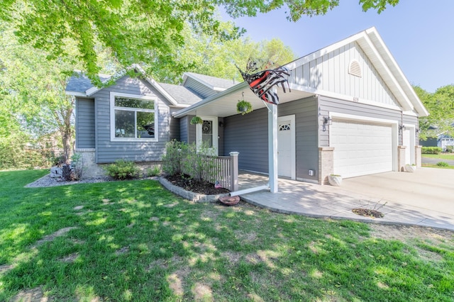 view of front of home featuring an attached garage, a front lawn, driveway, brick siding, and board and batten siding
