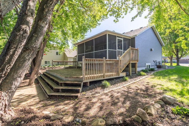 back of property with a sunroom and a wooden deck
