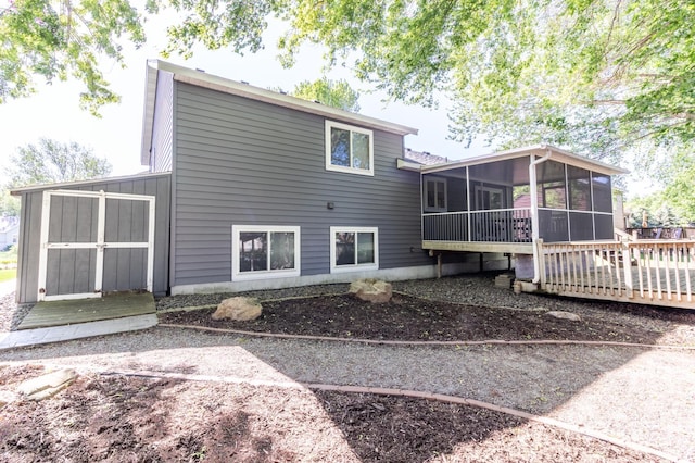 rear view of house featuring a sunroom
