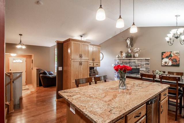 kitchen featuring wine cooler, dark wood-style flooring, a chandelier, a stone fireplace, and lofted ceiling