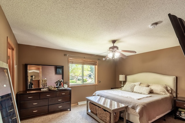 bedroom with light carpet, a textured ceiling, and ceiling fan