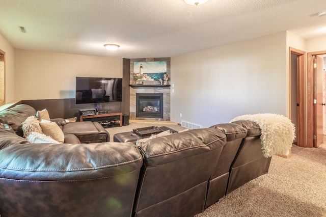 living area with carpet flooring and a glass covered fireplace