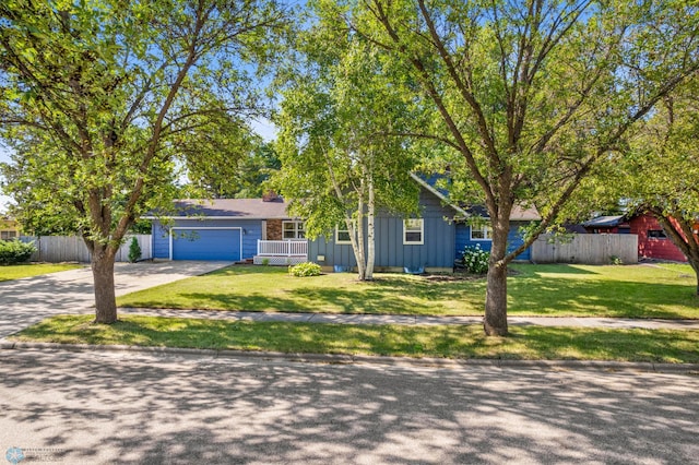 view of front of home featuring concrete driveway, board and batten siding, and a garage